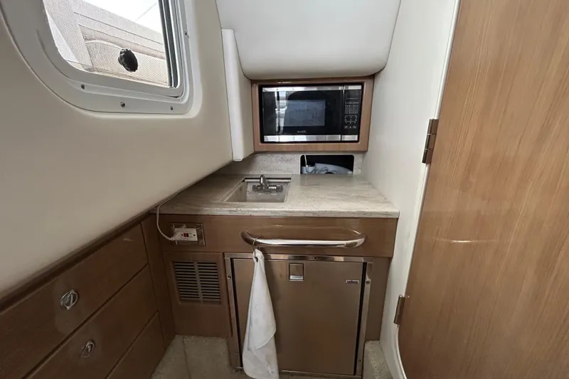 Sand Piper Yacht Photos Pics 2017 Formula 350 Crossover Bowrider interior kitchenette with sink, microwave, and storage.