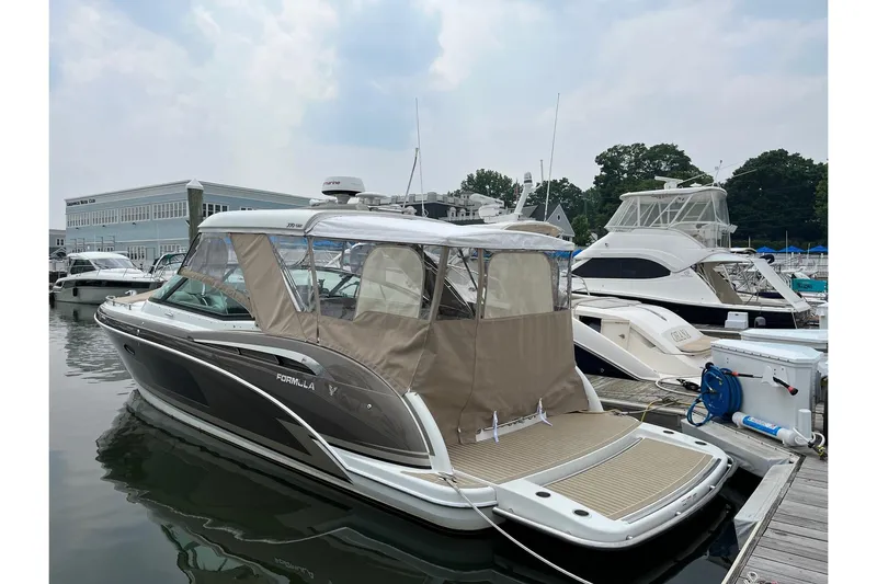Sand Piper Yacht Photos Pics 2017 Formula 350 Crossover Bowrider docked at marina, featuring sleek design and covered seating.