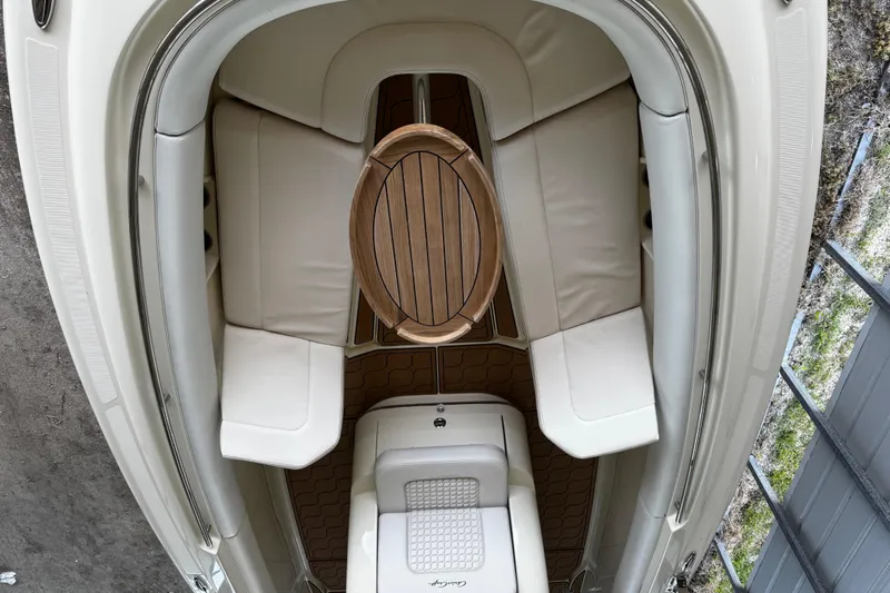  Yacht Photos Pics 2019 Chris-Craft Catalina 26 interior with cushioned seating and wooden table.