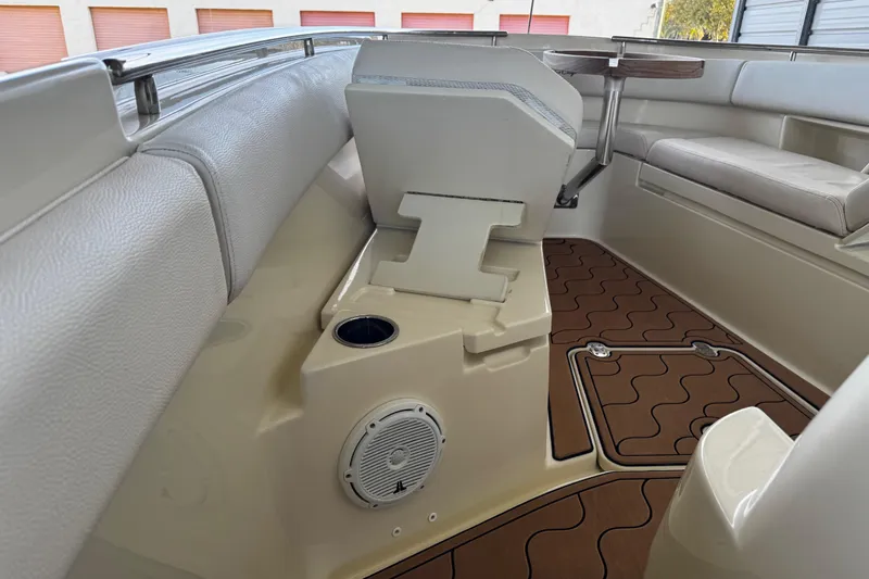  Yacht Photos Pics 2019 Chris-Craft Catalina 26 interior with seating, speaker, and wood-patterned flooring.