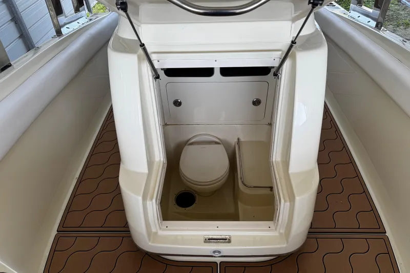  Yacht Photos Pics 2019 Chris-Craft Catalina 26 boat interior with compact toilet and seating area.