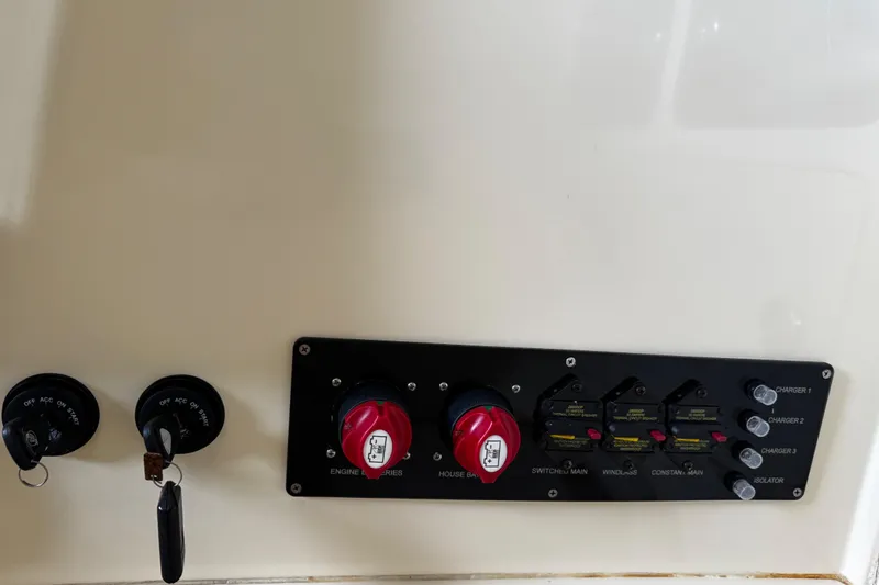  Yacht Photos Pics Control panel of a 2019 Chris-Craft Catalina 26 boat with switches and keys.