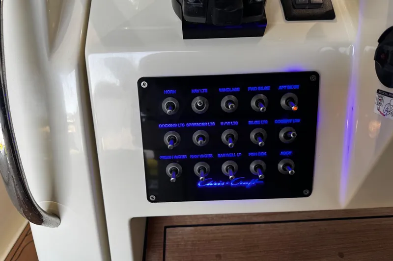  Yacht Photos Pics Control panel of a 2019 Chris-Craft Catalina 26 boat with labeled switches.