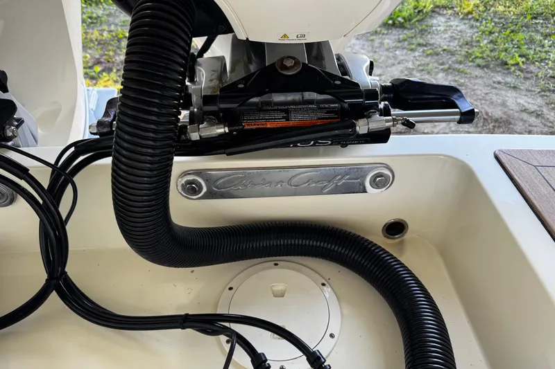  Yacht Photos Pics 2019 Chris-Craft Catalina 26 boat engine compartment with visible hoses and branding.