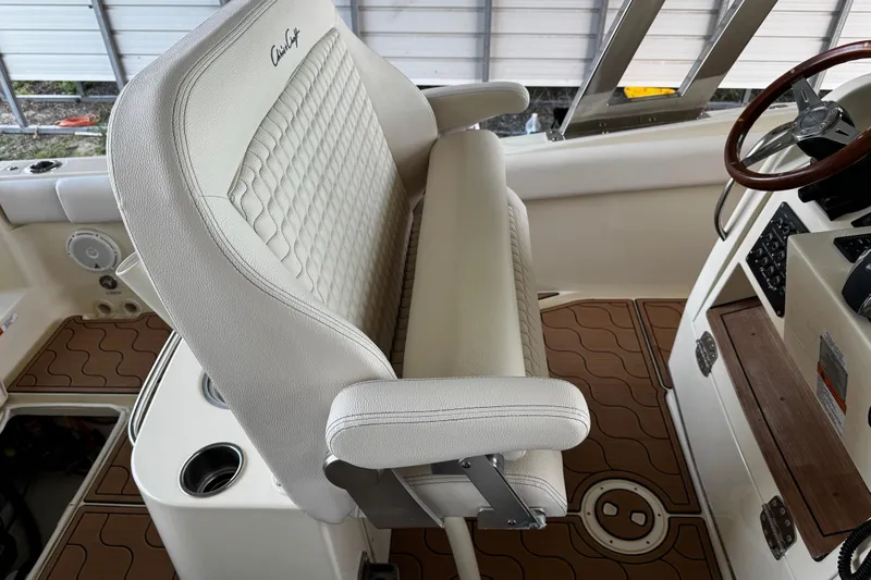  Yacht Photos Pics 2019 Chris-Craft Catalina 26 interior with white leather seating and wooden accents.