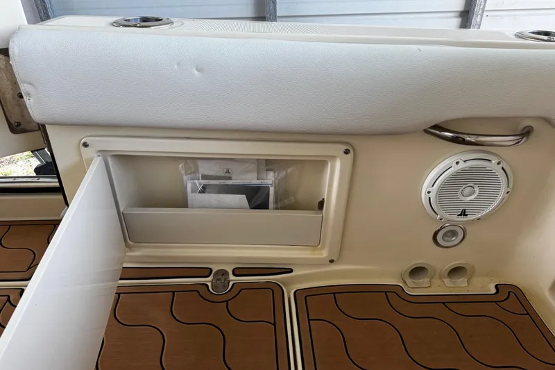  Yacht Photos Pics 2019 Chris-Craft Catalina 26 interior with storage compartment and speaker.