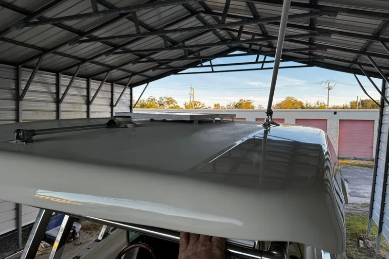  Yacht Photos Pics 2019 Chris-Craft Catalina 26 under metal shelter, showcasing roof details.