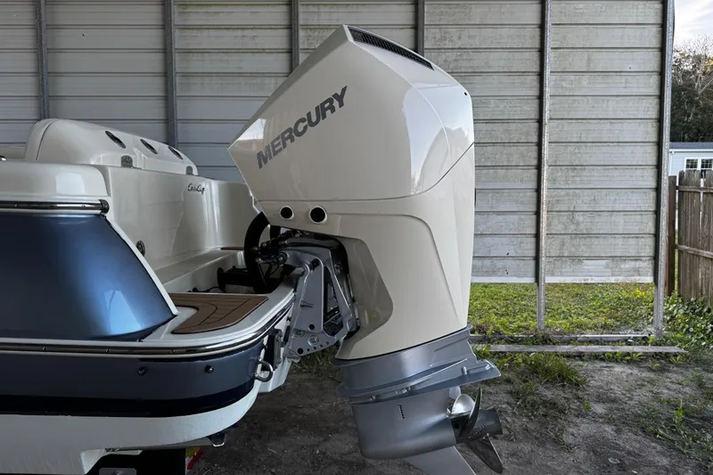  Yacht Photos Pics 2019 Chris-Craft Catalina 26 with Mercury outboard engine in a storage area.