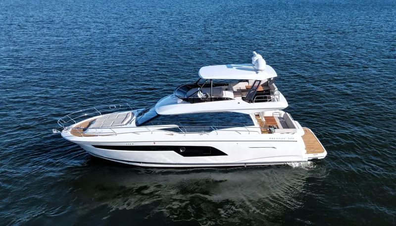 Sandybay Yacht Photos Pics 2022 Prestige 520 Fly yacht cruising on open water.