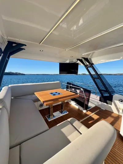 Sandybay Yacht Photos Pics Luxurious 2022 Prestige 520 Fly yacht interior with elegant seating and scenic ocean view.