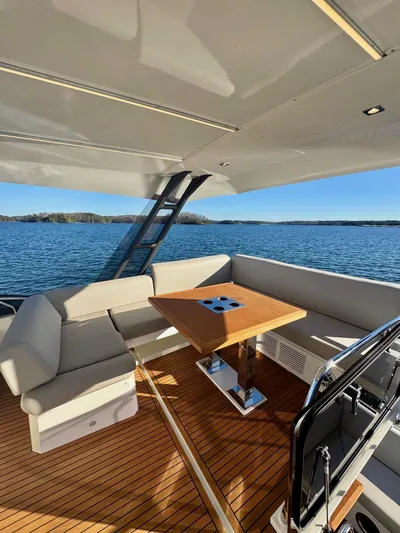 Sandybay Yacht Photos Pics Luxurious 2022 Prestige 520 Fly yacht with elegant seating and scenic water view.