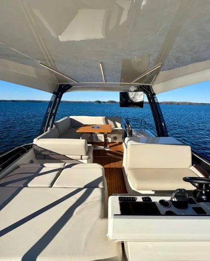 Sandybay Yacht Photos Pics Luxurious 2022 Prestige 520 Fly yacht interior with elegant seating and ocean view.