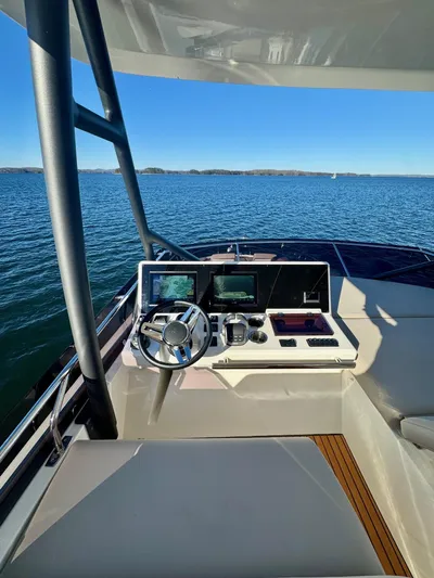 Sandybay Yacht Photos Pics Prestige 520 Fly 2022 yacht helm with navigation screens on open water.