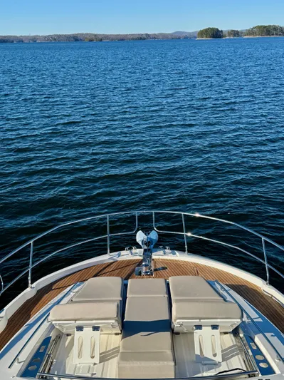 Sandybay Yacht Photos Pics Prestige 520 Fly 2022 yacht on calm blue water with scenic horizon.