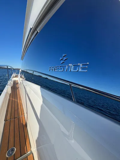 Sandybay Yacht Photos Pics Prestige 520 Fly yacht, 2022 model, sleek design with wooden deck and ocean view.
