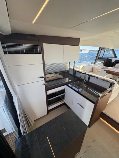 Sandybay Yacht Photos Pics Modern kitchen interior on 2022 Prestige 520 Fly yacht, featuring sleek design and ocean view.