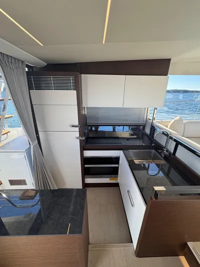 Sandybay Yacht Photos Pics Modern kitchen interior on 2022 Prestige 520 Fly yacht with sleek cabinetry and ocean view.