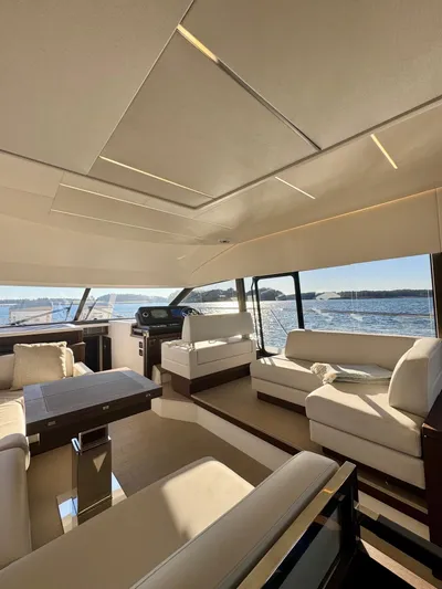 Sandybay Yacht Photos Pics Luxurious interior of 2022 Prestige 520 Fly yacht with elegant seating and panoramic windows.