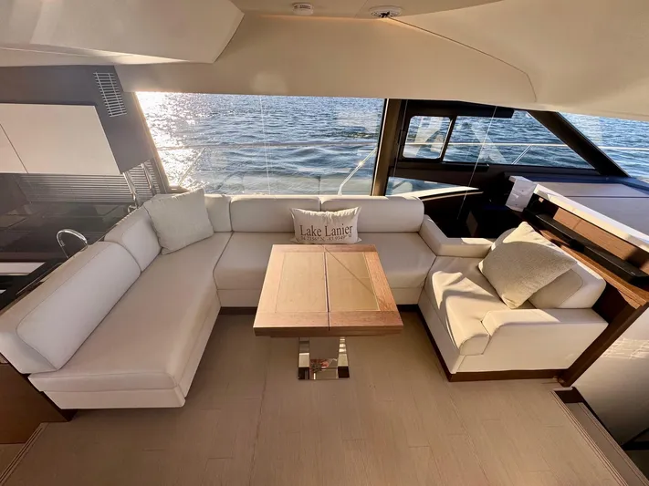 Sandybay Yacht Photos Pics Luxurious 2022 Prestige 520 Fly yacht interior with elegant seating and ocean view.