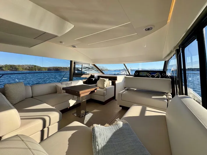 Sandybay Yacht Photos Pics Luxurious interior of 2022 Prestige 520 Fly yacht with elegant seating and panoramic views.