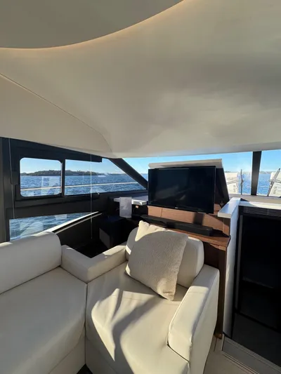 Sandybay Yacht Photos Pics Luxurious interior of 2022 Prestige 520 Fly yacht with modern seating and sea view.