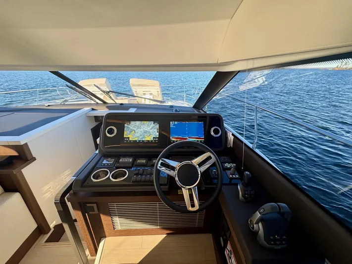Sandybay Yacht Photos Pics Prestige 520 Fly 2022 yacht helm with navigation screens and ocean view.
