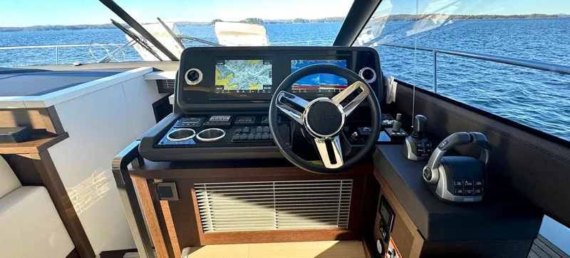 Sandybay Yacht Photos Pics Prestige 520 Fly 2022 yacht helm with navigation screens and steering wheel on open water.