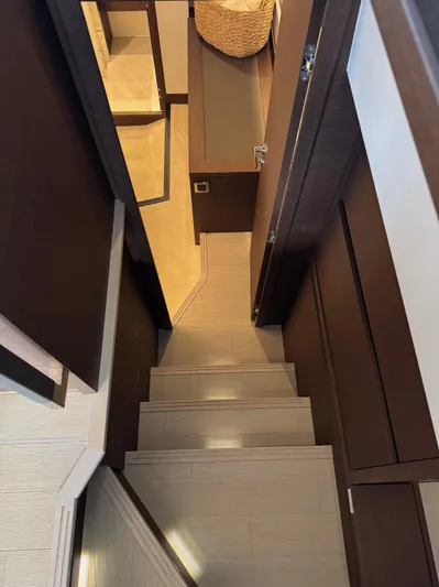 Sandybay Yacht Photos Pics Interior stairs of 2022 Prestige 520 Fly yacht, featuring modern design and wood finish.