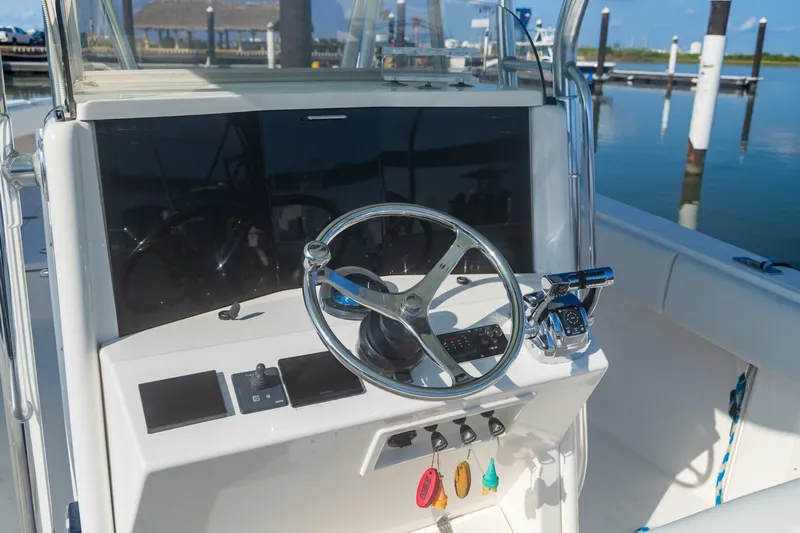 4 Getaway Yacht Photos Pics 2005 Venture 39 Open boat helm with steering wheel and controls.