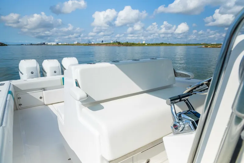 4 Getaway Yacht Photos Pics 2005 Venture 39 Open boat on calm water, clear sky, and scenic background.