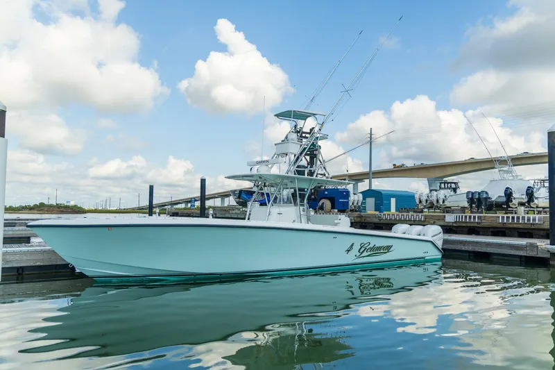 4 Getaway Yacht Photos Pics 2005 Venture 39 Open boat docked in a marina under a cloudy sky.