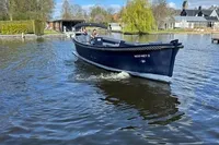 A 2018 Davy & Orsted 10.50 open boat cruising on a scenic river.