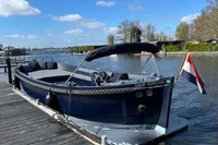 2018 Davy & Orsted 10.50 Open boat docked by a serene lake under blue skies.