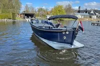 2018 Davy & Orsted 10.50 open boat cruising on a sunny lake.