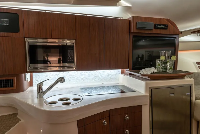 Between Wakes Yacht Photos Pics Manufacturer Provided Image: Modern kitchen area in 2020 Grady-White Express 330 boat with microwave and sink.