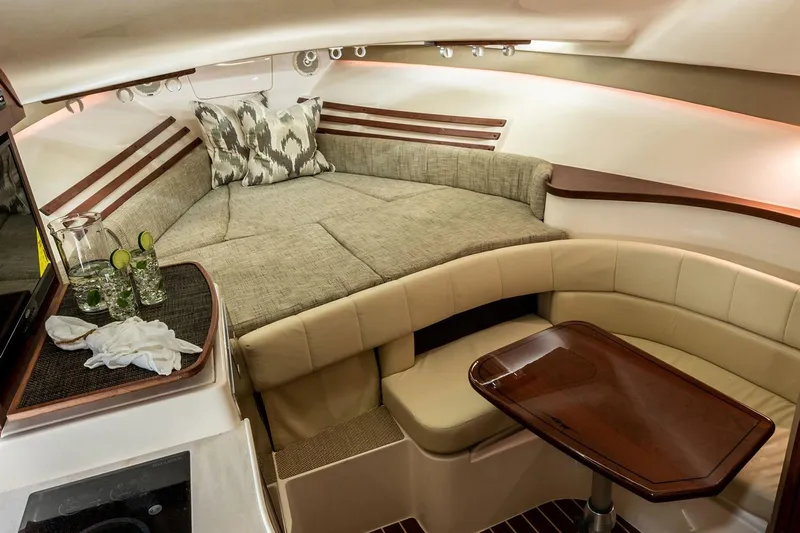 Between Wakes Yacht Photos Pics Manufacturer Provided Image: 2020 Grady-White Express 330 cabin interior with bed, table, and seating area.