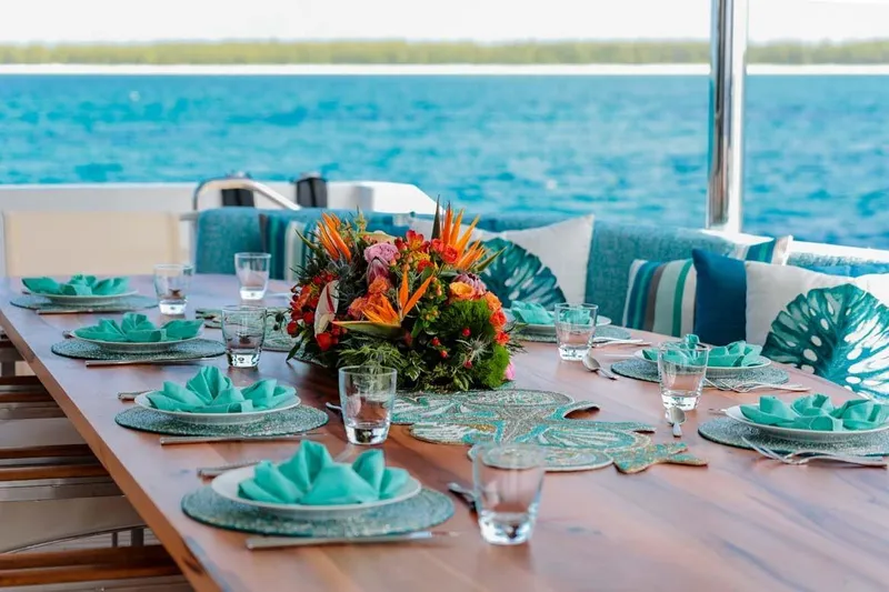 Cupcake Yacht Photos Pics Elegant dining setup on 2001 Westship Skylounge yacht with ocean view and floral centerpiece.