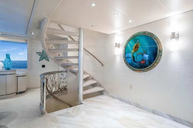 Cupcake Yacht Photos Pics Luxurious 2001 Westship Skylounge interior with spiral staircase and ocean-themed decor.