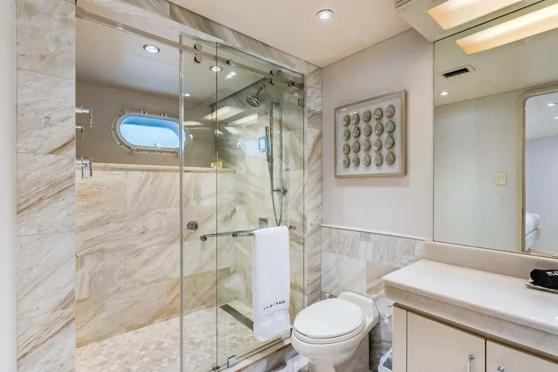 Cupcake Yacht Photos Pics Luxurious bathroom in 2001 Westship Skylounge yacht with marble shower and elegant fixtures.