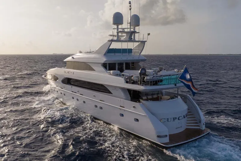 Cupcake Yacht Photos Pics Luxury 2001 Westship Skylounge yacht cruising on open sea at sunset.