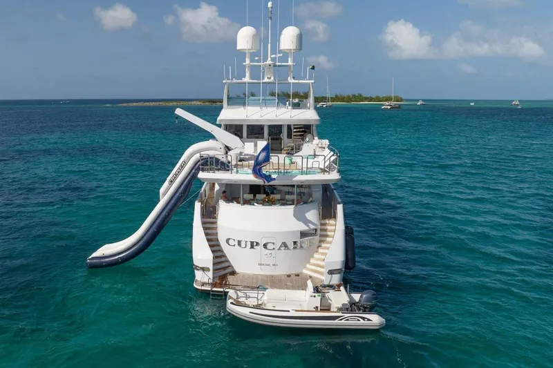 Cupcake Yacht Photos Pics Luxury 2001 Westship Skylounge yacht with slide, anchored in clear blue ocean.