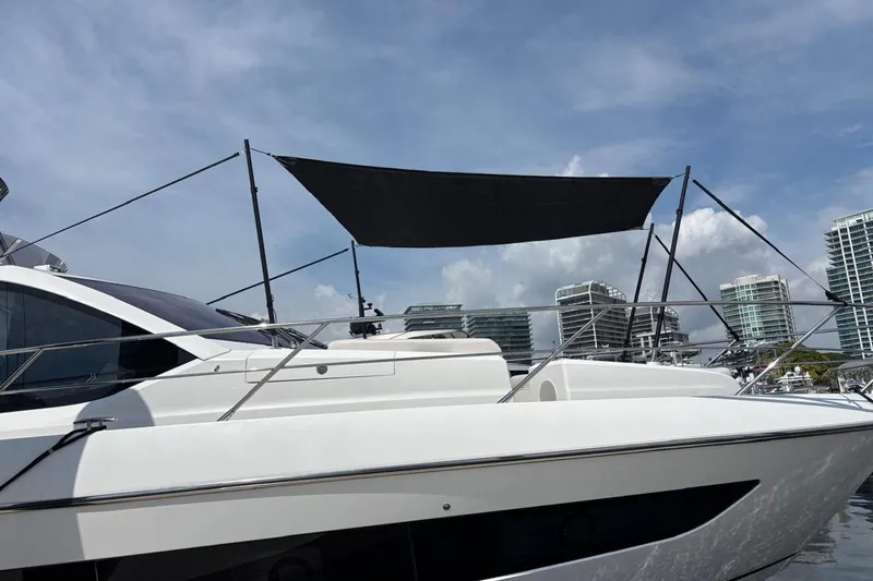 Atkun Yacht Photos Pics 2021 Sunseeker Manhattan 68 yacht docked, featuring sleek design and modern architecture.