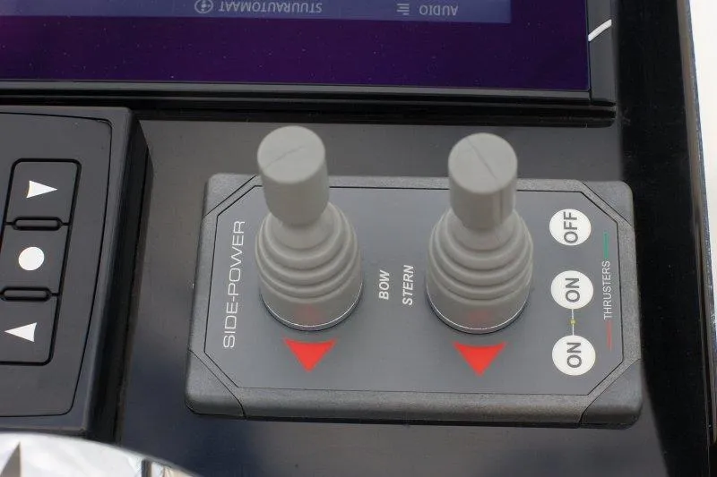  Yacht Photos Pics Control panel of 2022 Beneteau Oceanis Yacht 54 with side-power thruster joysticks.