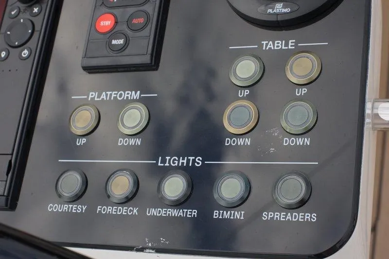  Yacht Photos Pics Control panel of 2022 Beneteau Oceanis Yacht 54 with platform and light switches.