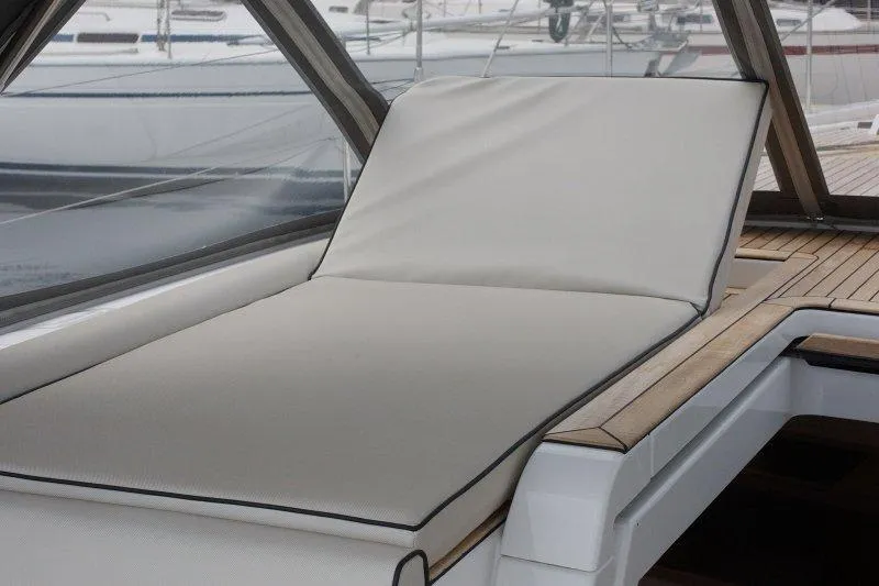  Yacht Photos Pics Luxury sunbed on 2022 Beneteau Oceanis Yacht 54 deck, featuring sleek design and comfort.
