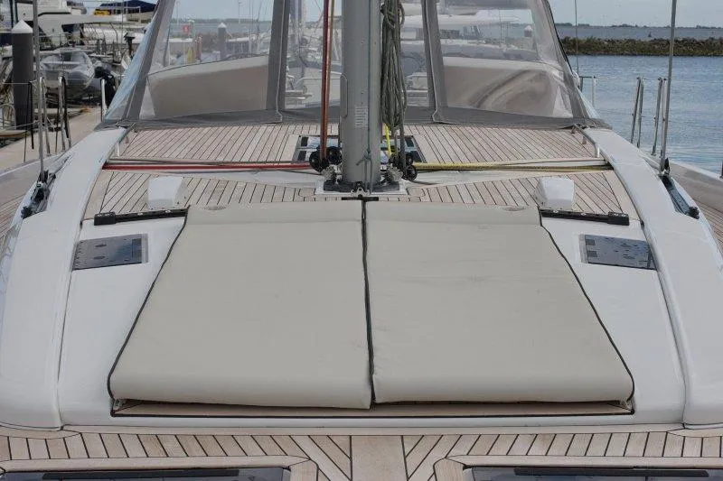  Yacht Photos Pics 2022 Beneteau Oceanis Yacht 54 deck with sunbathing area and sleek design.