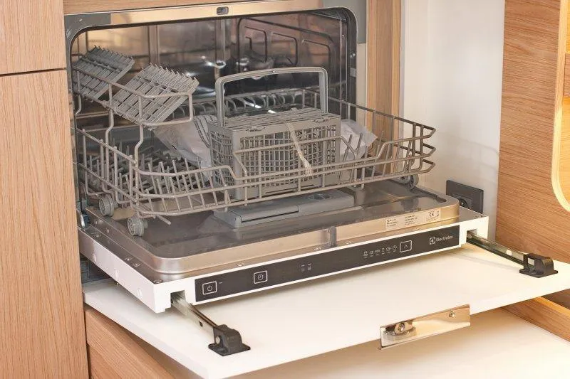  Yacht Photos Pics Built-in dishwasher on Beneteau Oceanis Yacht 54, 2022 model, with open door and racks.