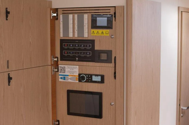  Yacht Photos Pics Control panel inside 2022 Beneteau Oceanis Yacht 54, featuring various switches and displays.