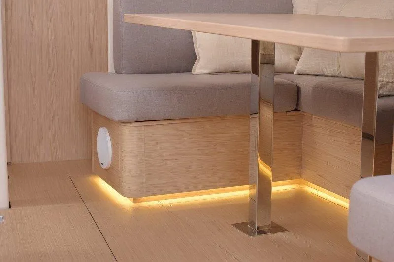  Yacht Photos Pics Modern interior of 2022 Beneteau Oceanis Yacht 54 with elegant seating and ambient lighting.