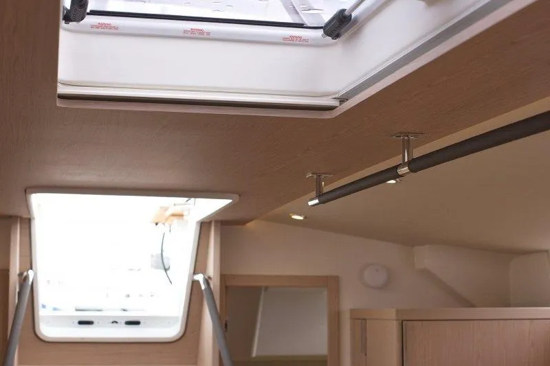  Yacht Photos Pics Interior view of 2022 Beneteau Oceanis Yacht 54, featuring a skylight and modern design.